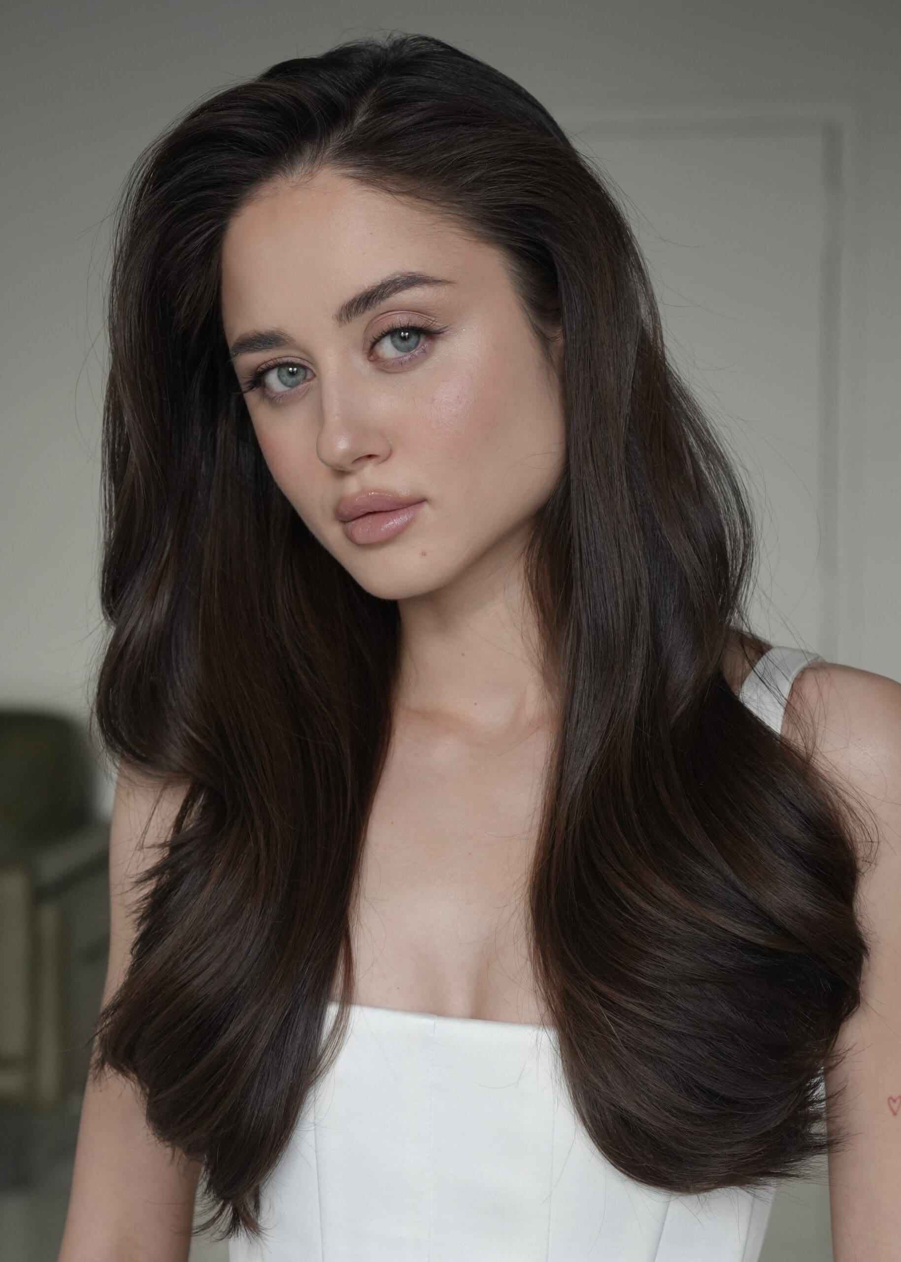 stunning bride with black layered hair poses for a photo, the layered looks are a top favorite of 2026 hair trends so far!