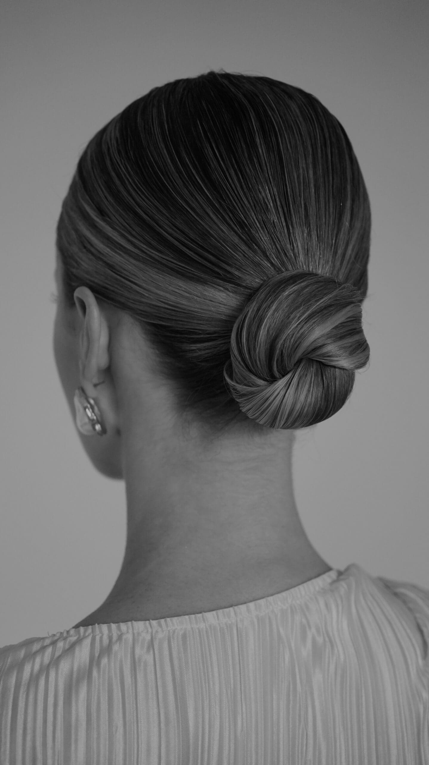 the sleek bun is becoming a modern day classic for bridal hairstyles, as a 2026 hair trend they stay on the list!