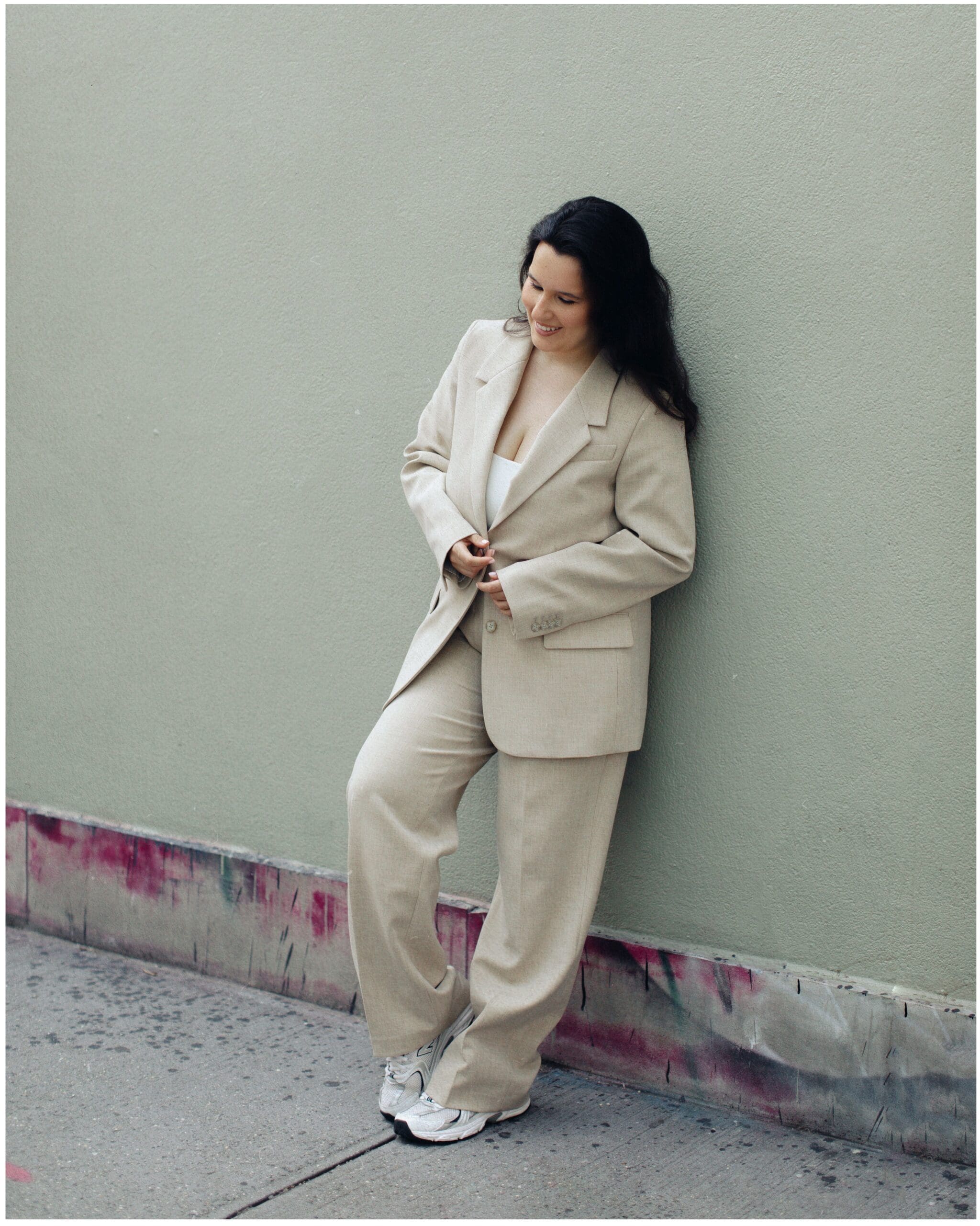 Sophie poses for a photo leaning against a NYC wall