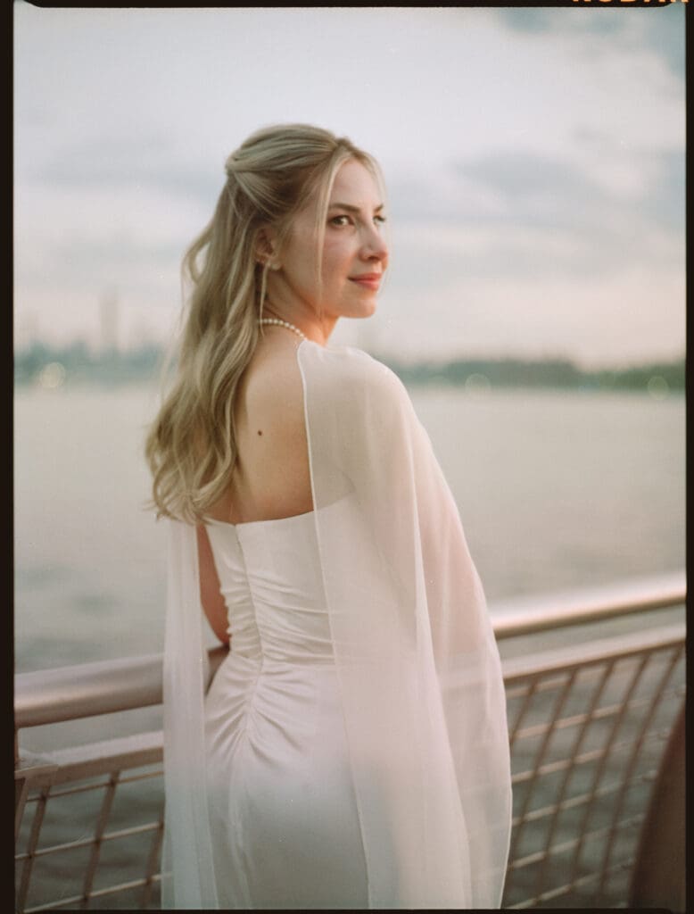 bride poses for a photo during her bridal beauty timeline on her wedding day