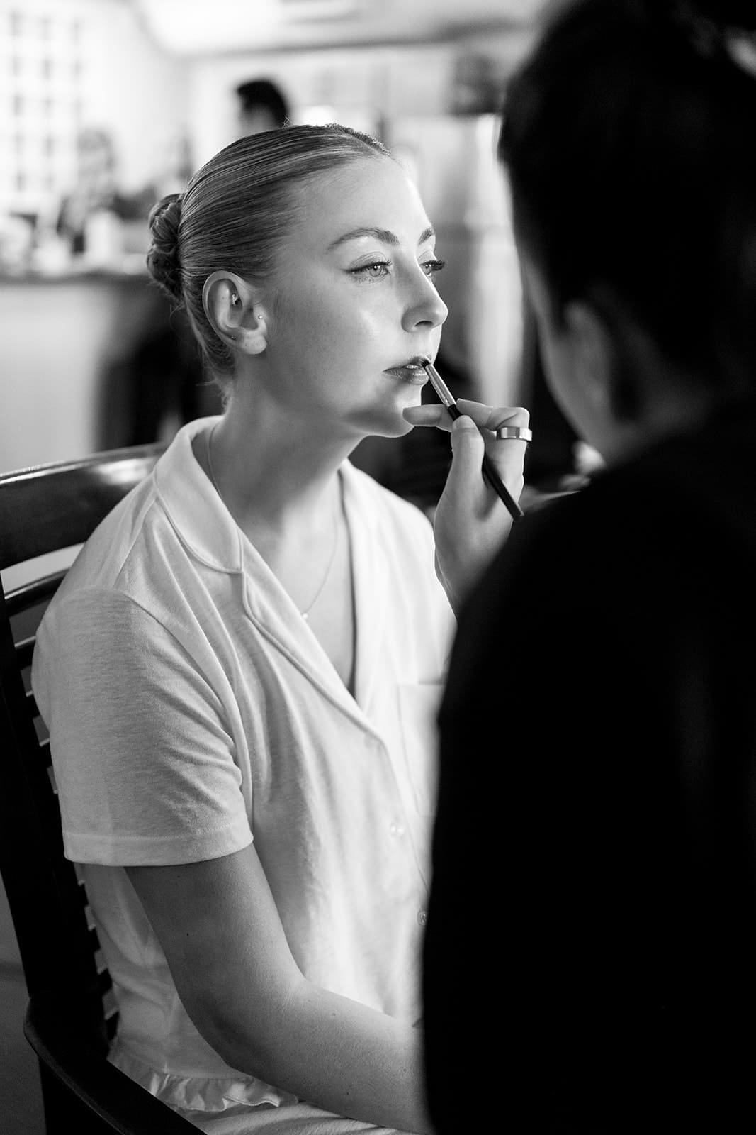 bride gets prepped for her wedding day during her bridal beauty timeline 