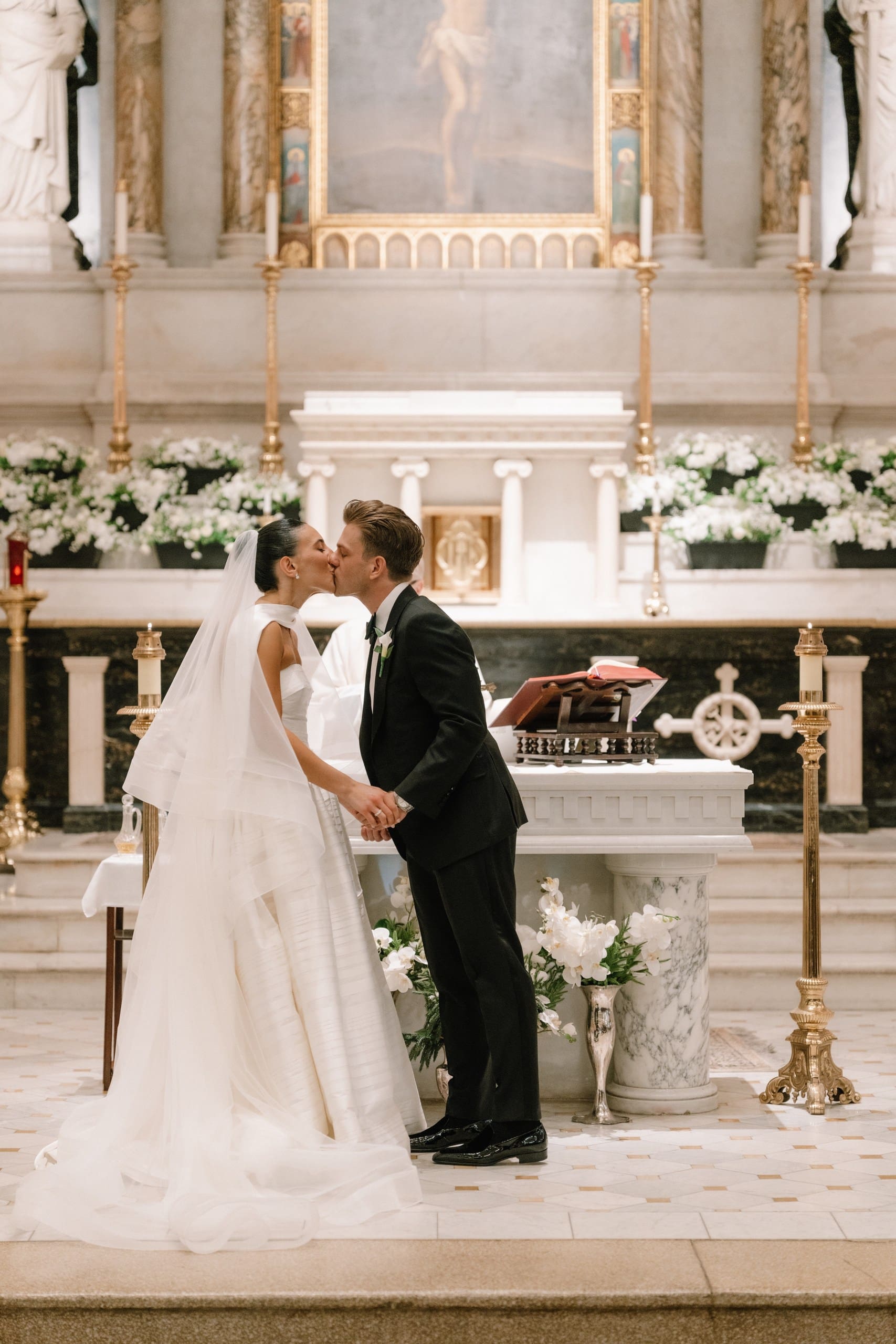 bride and groom share a kiss as their wedding comes to an end