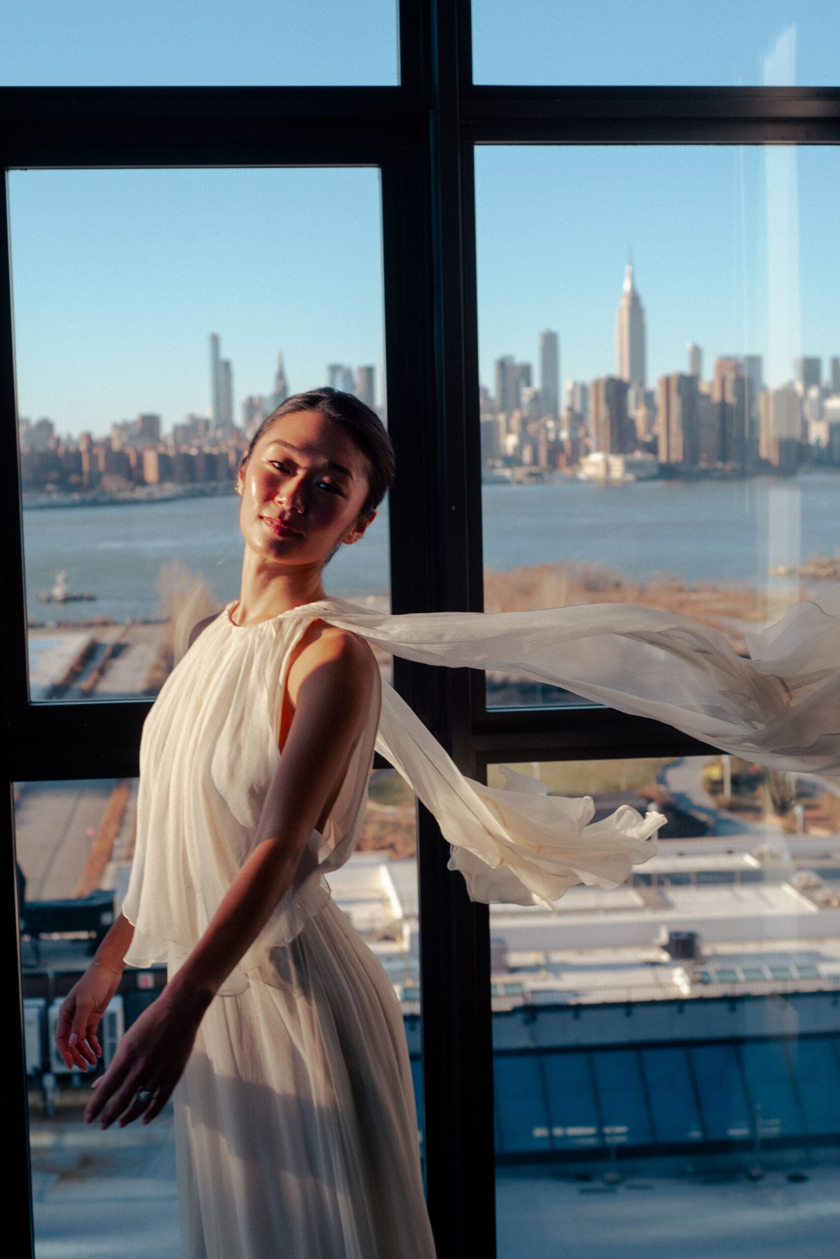 bride is glowing with the water in the background after NYC wedding vendor SM beauty helped her prepare for